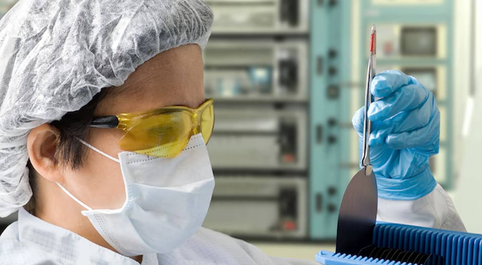 Cleanroom technician inspecting a wafer
